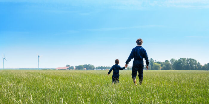 father and son in a pasture